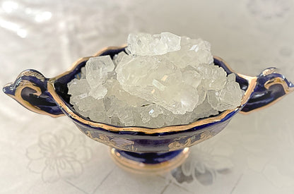 Blue and gold ceramic bowl filled with clear nabat crystals