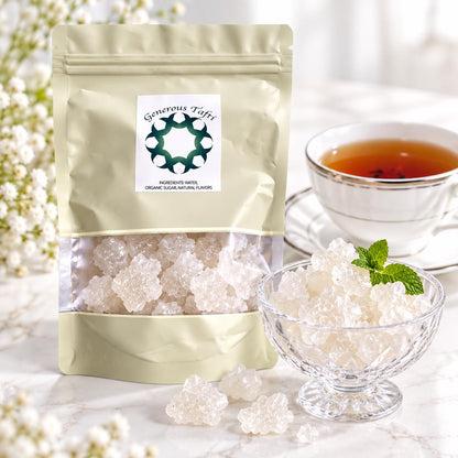 Stand-up pouch of crystal rock candy beside a glass bowl with a mint leaf